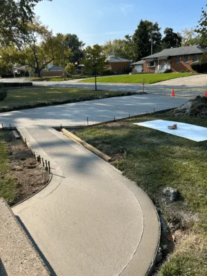 Newly poured concrete slab foundation set within framed site prep in Windsor.