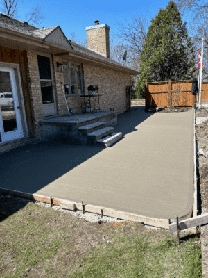 Fresh concrete pad foundation in Windsor New concrete pad freshly poured and smoothed inside framed site in Windsor.